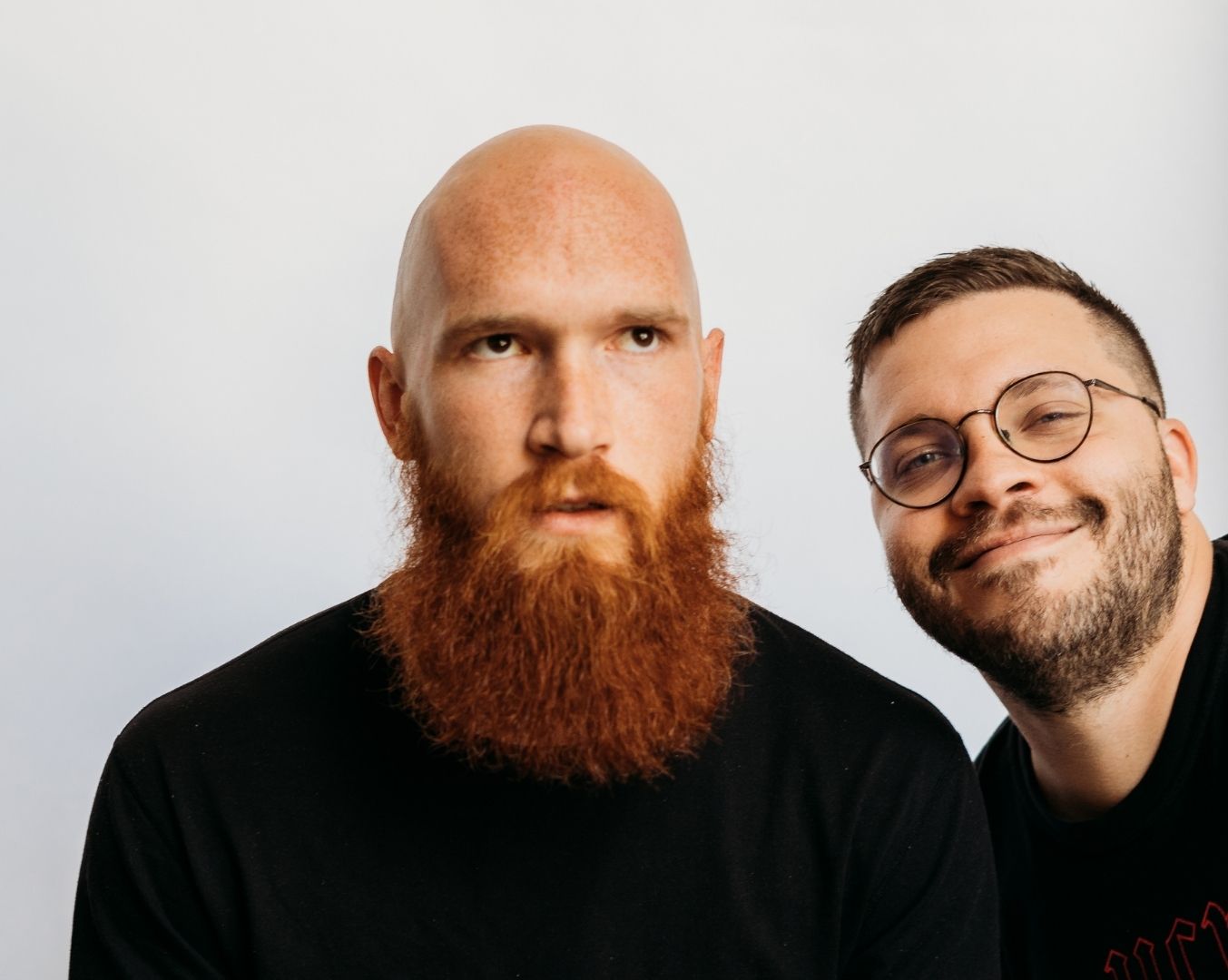 Two men with beards smiling